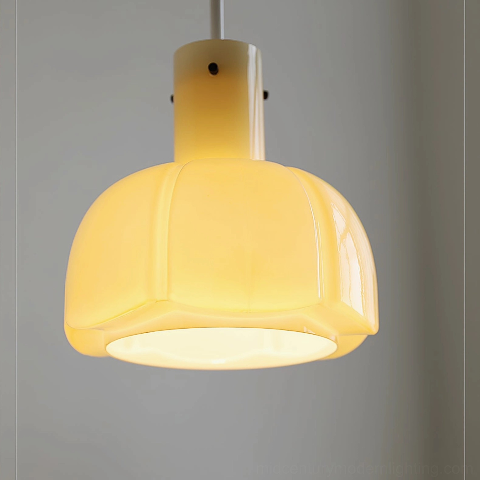 Cream colored Paolina pumpkin pendant light warm tone glass shade in contemporary home setting