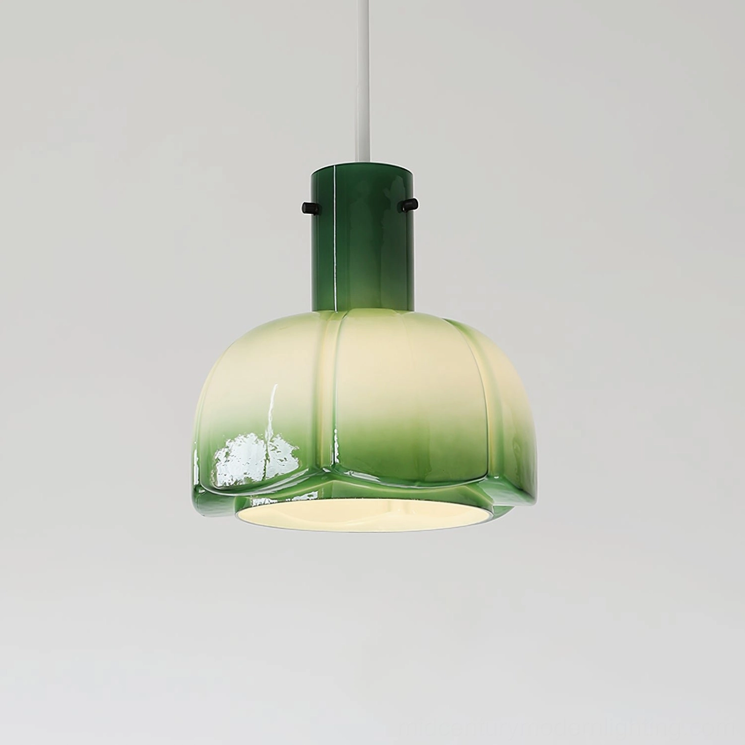 Gradient jade green Paolina glass pendant light overhead view against light grey wall background