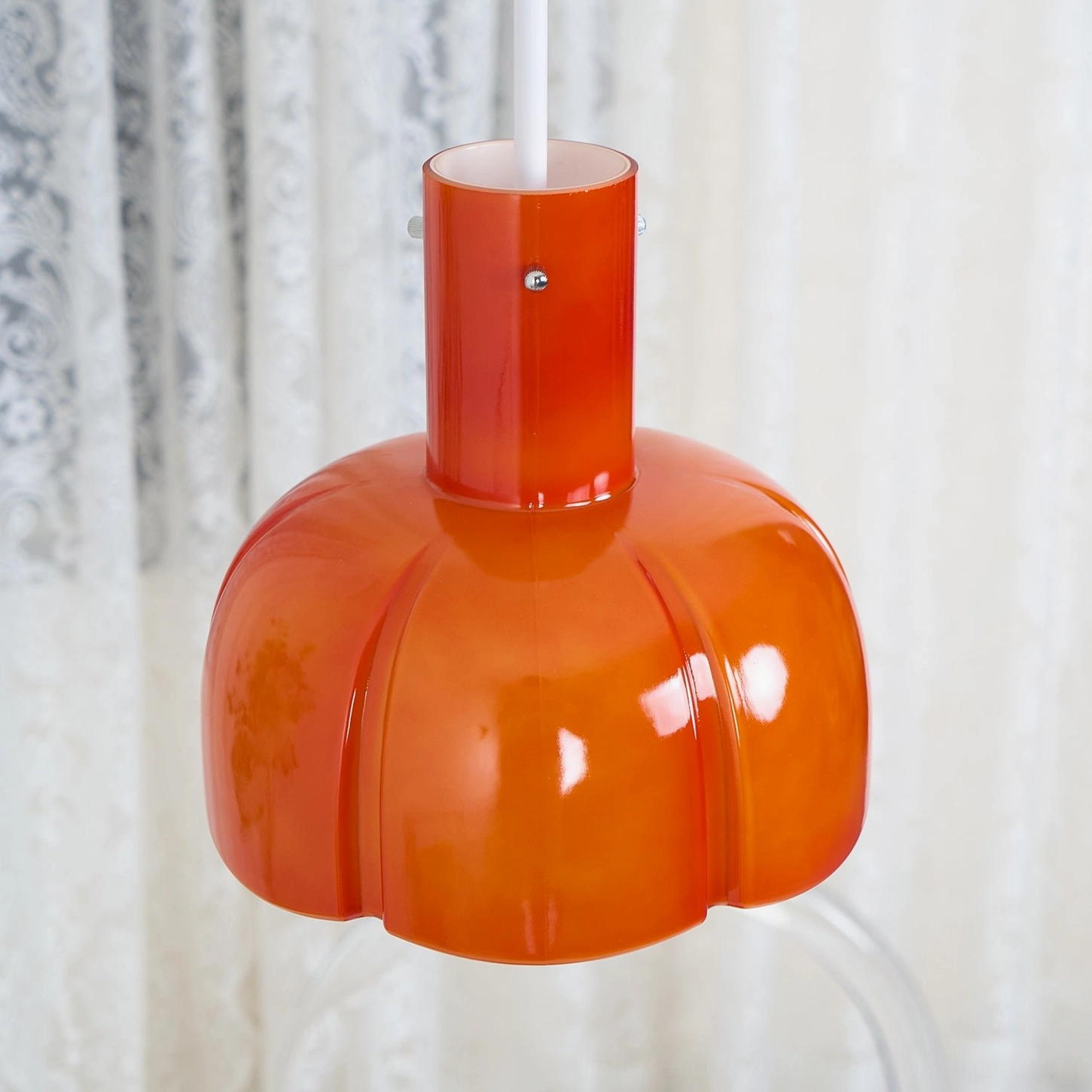 Paolina pumpkin glass pendant showing metal mounting framework and cord attachment detail