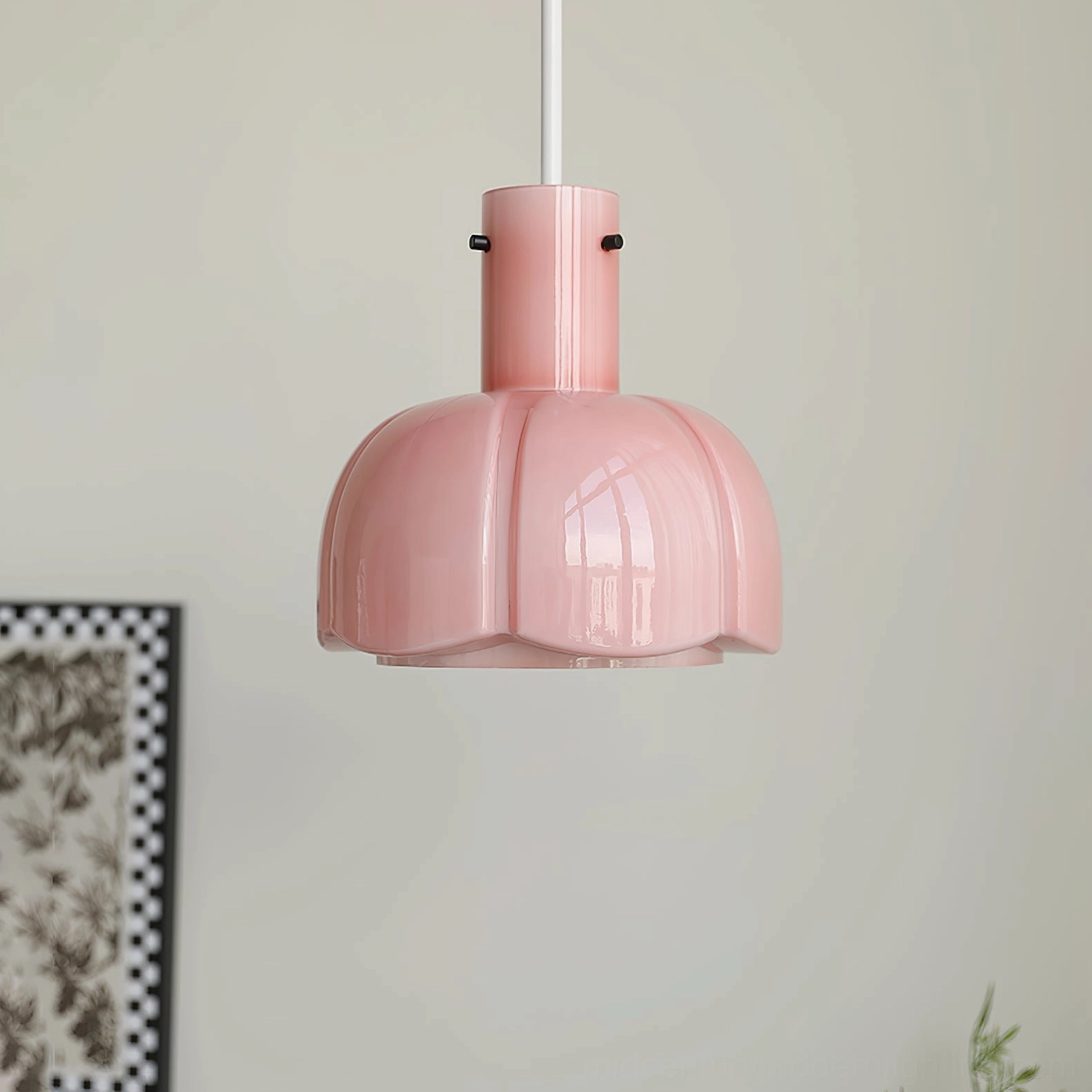 Soft pastel pink Paolina glass pendant light three-quarter view in minimalist space with wall artwork