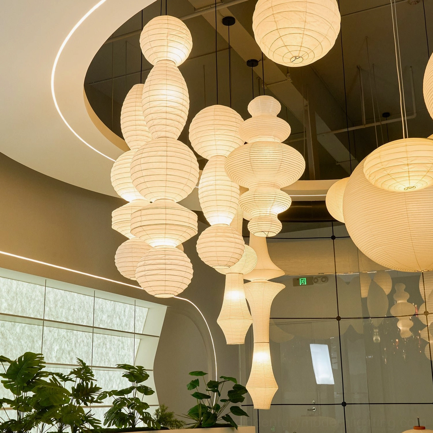 Paper pendant lanterns commercial space varied styles warm glow artistic installation