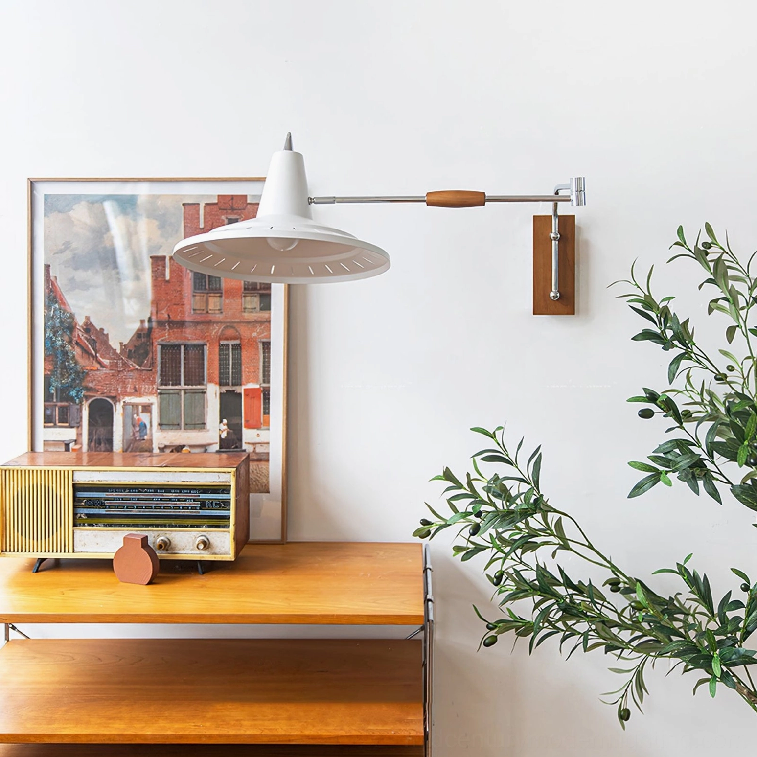 Low angle view of modern swing arm wall lamp in minimalist home space with framed art, wooden furniture and vintage aesthetic