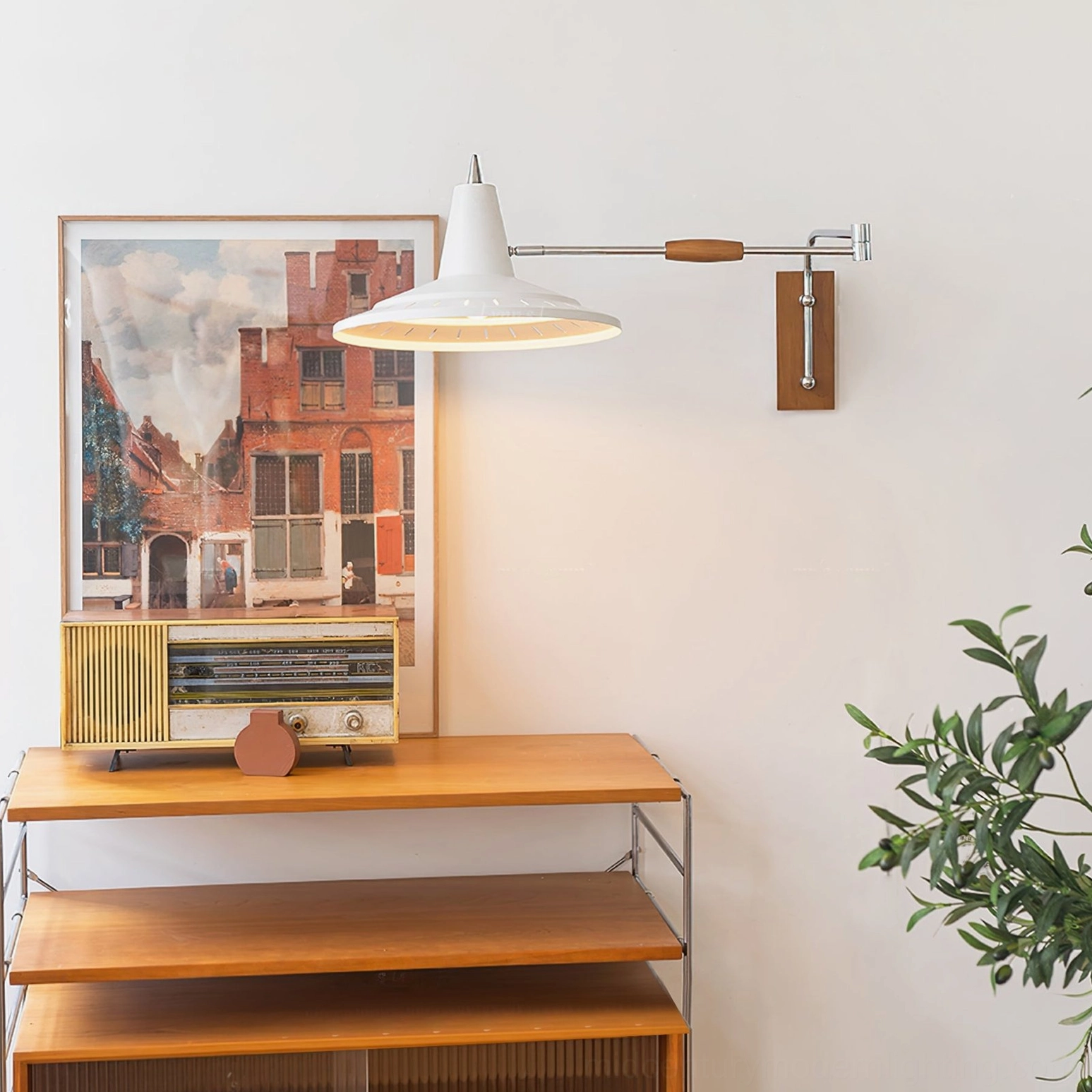 Swing arm wall lamp installed in vintage home interior with wooden side table, retro radio and warm neutral décor styling
