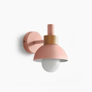 Pastel pink dome wall sconce with natural wood collar, frontal studio view showcasing modern minimalist design