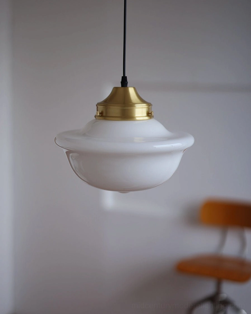 Classic Pathson mid-century pendant light with opal glass shade and brass fixture in modern home corner