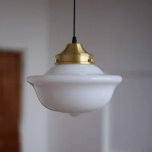 Close-up detail of Pathson mid-century pendant light showing curved opal glass and polished brass hardware