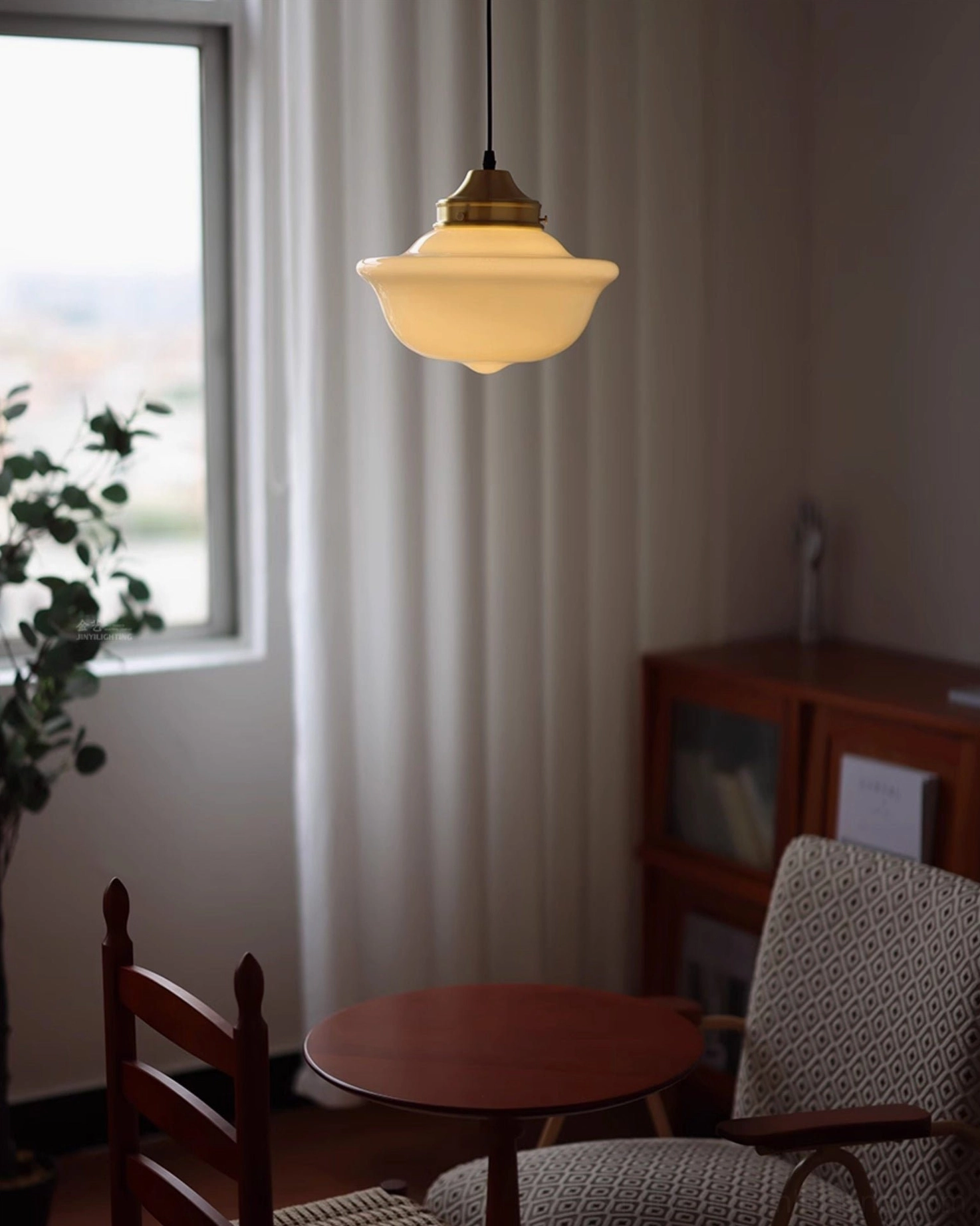 Pathson mid-century pendant light illuminated in vintage dining room with warm glow and wooden furniture
