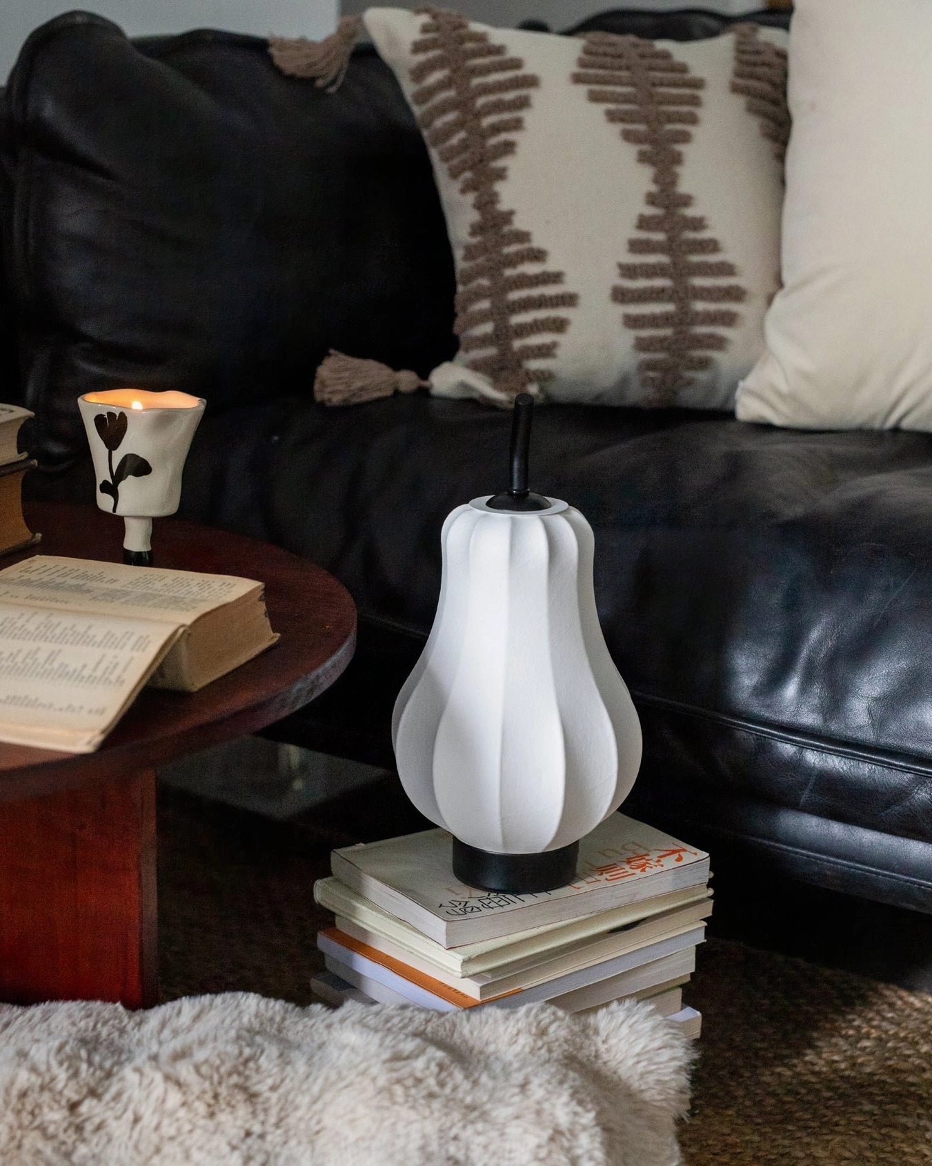 Decorative pear cordless lamp creating warm ambient lighting in styled room setting
