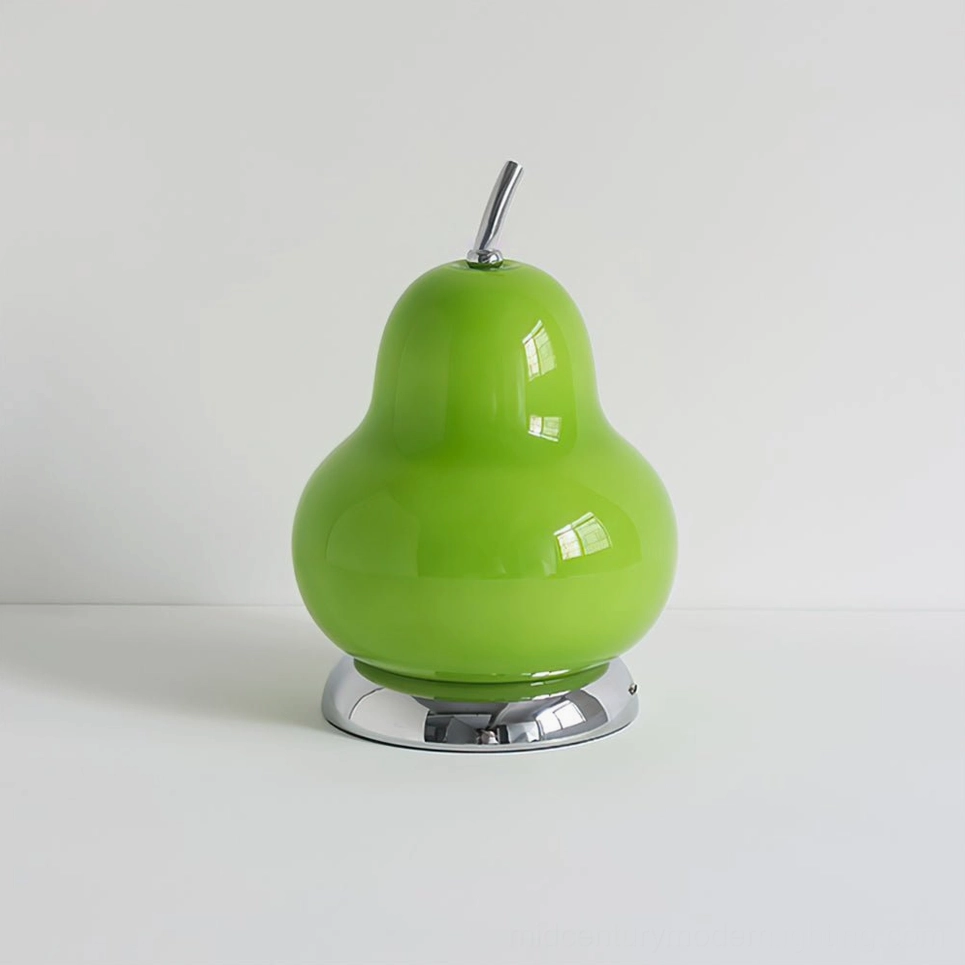 Contemporary green pear-shaped glass table lamp with chrome metal base on white tabletop, clean minimalist presentation
