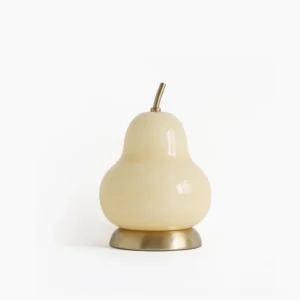 Pear-shaped glass cordless table lamp with cream glass and brass base, front studio view on white background