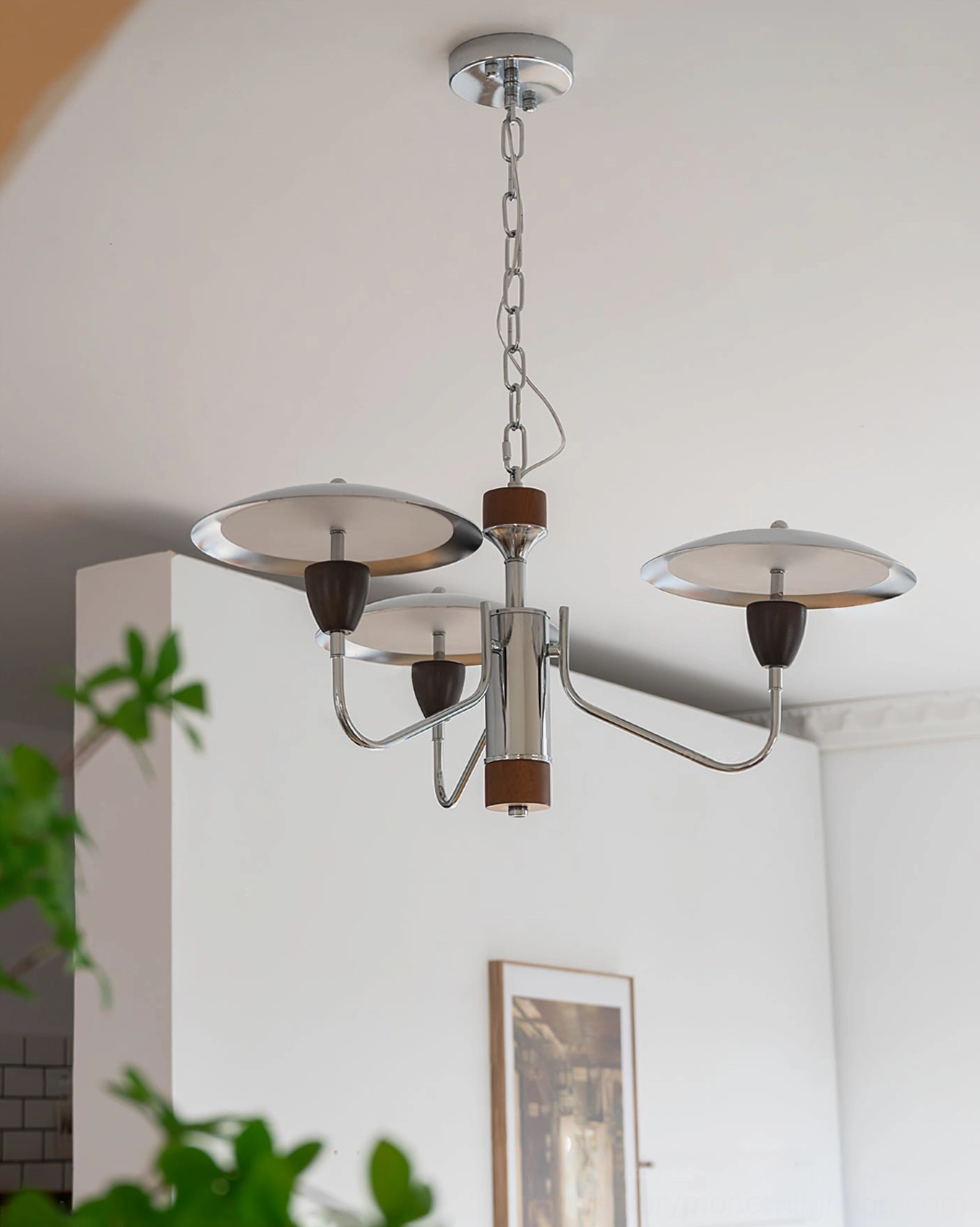 Peggy 3-head chrome chandelier in bright white residential space, showing chrome arms walnut wood center and geometric design lines