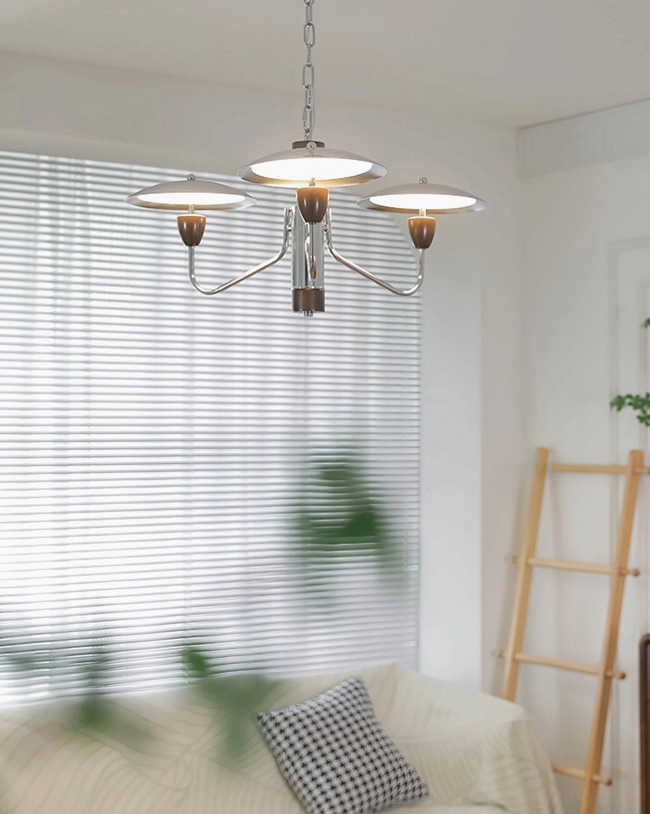 Peggy 3-head compact chandelier in bright living room with window blinds and striped sofa, demonstrating residential scale and warm ambiance