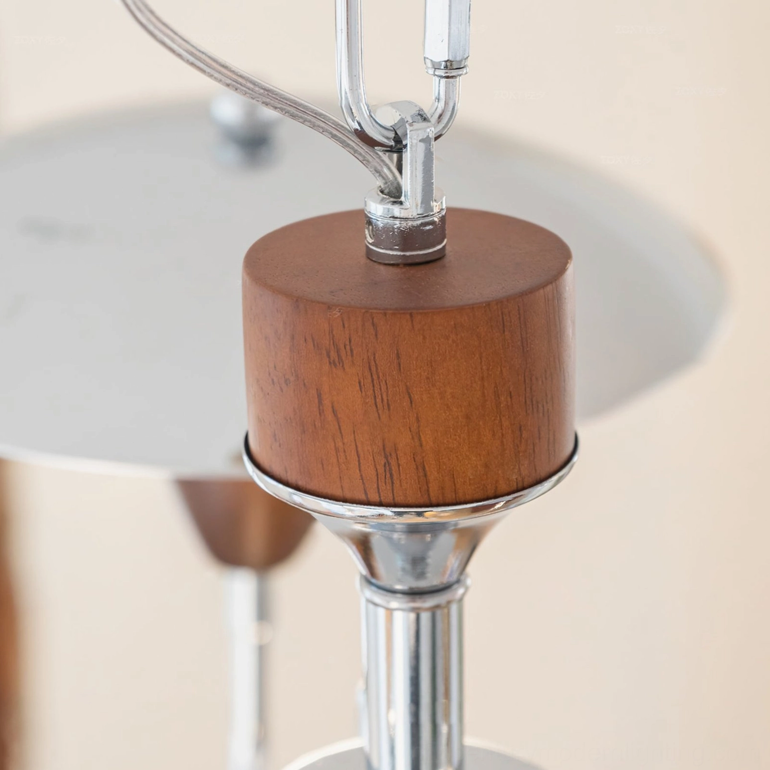 Peggy chandelier ceiling mount detail showing chrome plating and walnut wood insert, close-up hardware view