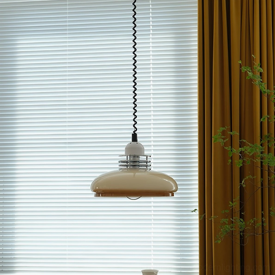 Vintage mid-century modern pendant lamp creating warm ambient lighting in styled home interior with period furnishings