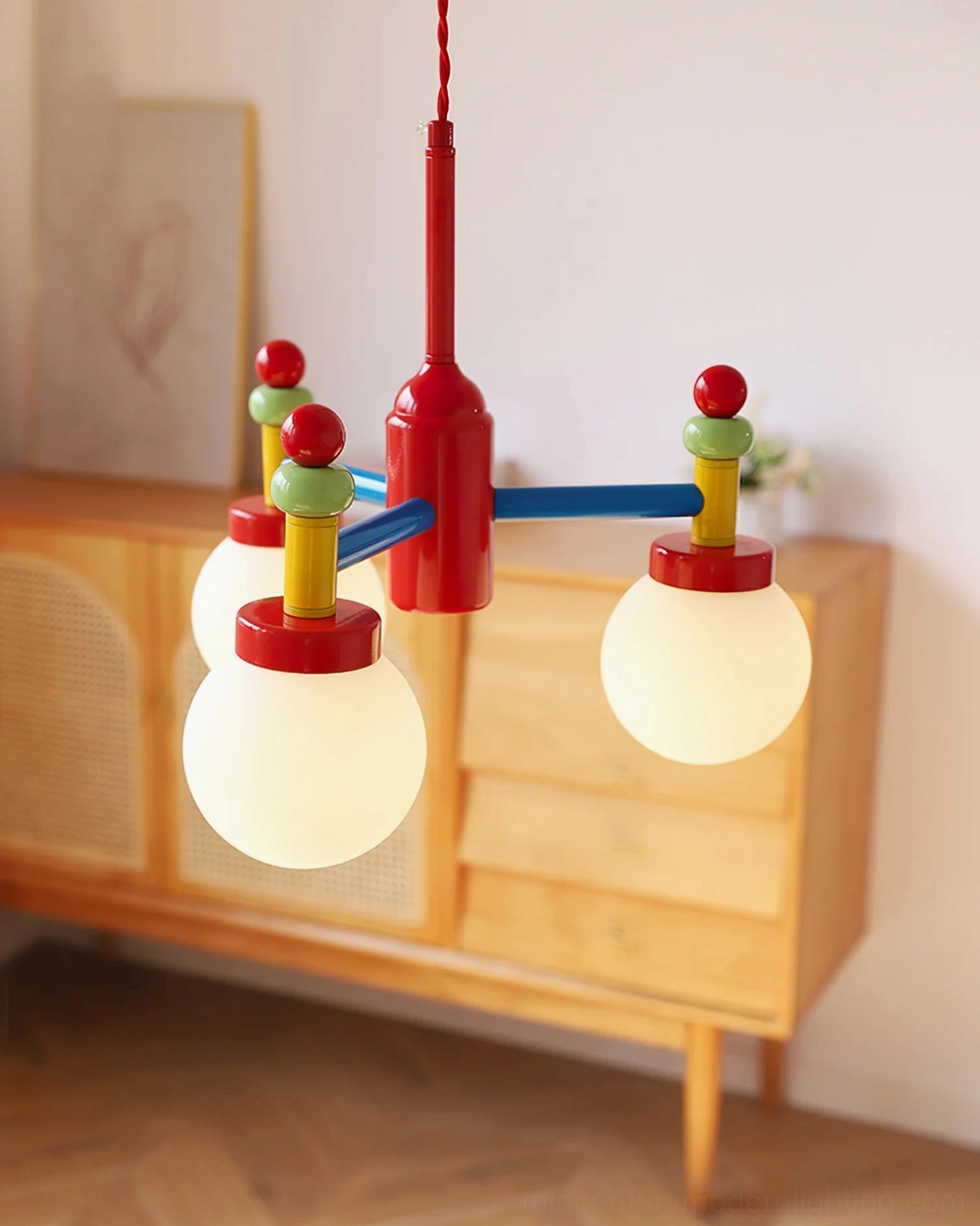 Lit pendant lamp beside wooden cabinet showing warm ambient glow and color-coordinated design