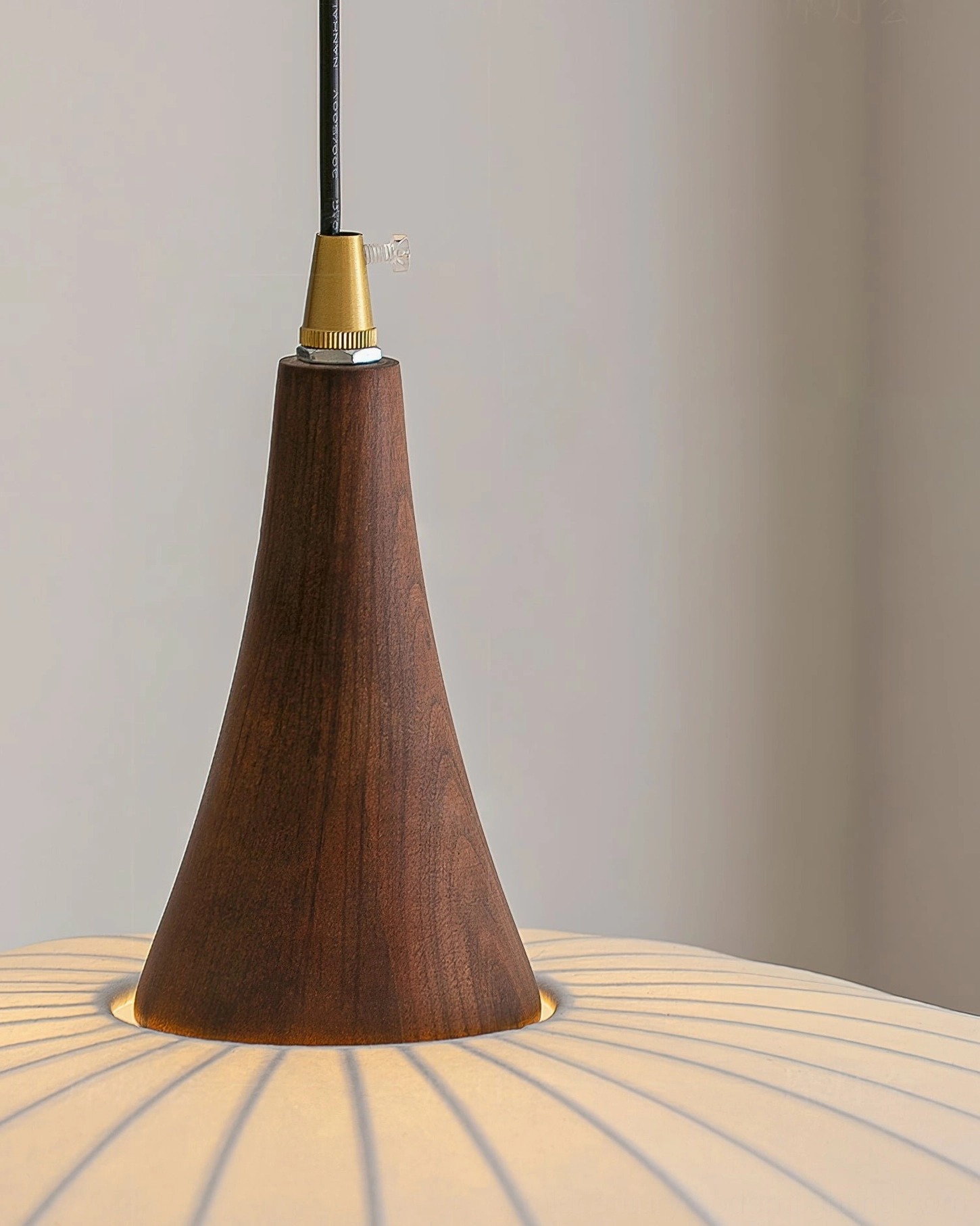 Pendant light hanging adapter with brass metal and dark walnut tapered solid wood base, bottom close-up detail
