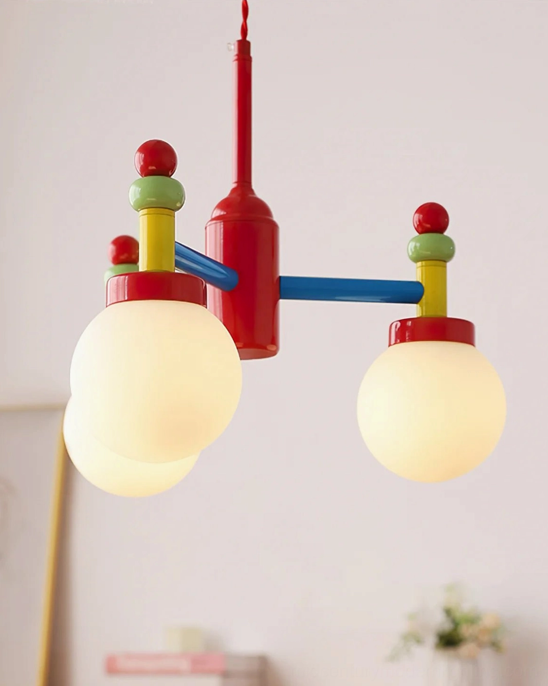 Close-up side view of illuminated colorful pendant lamp with warm bulb glow