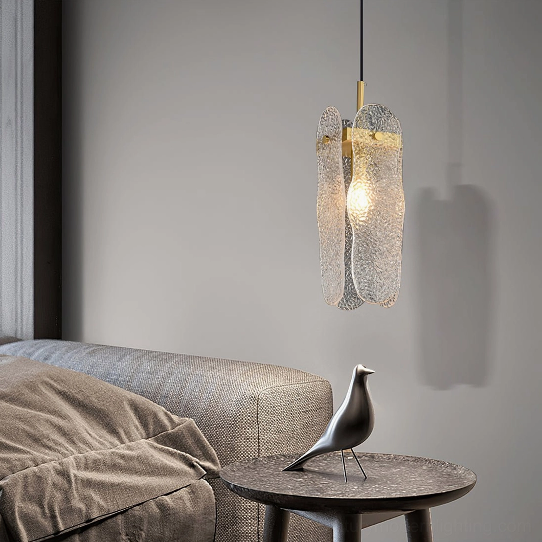 Modern glass pendant above marble side table living room with fabric sofa decor