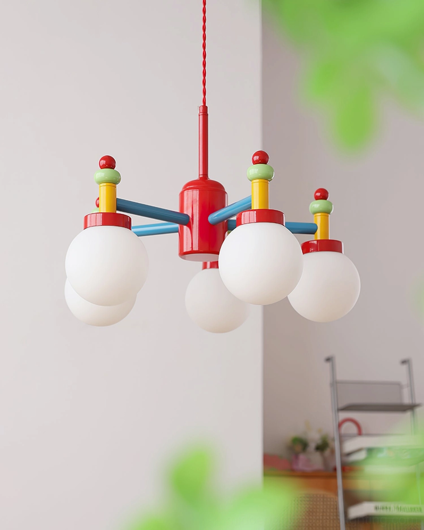 Multi-head pendant light overhead view with metal shelf and green decorative elements