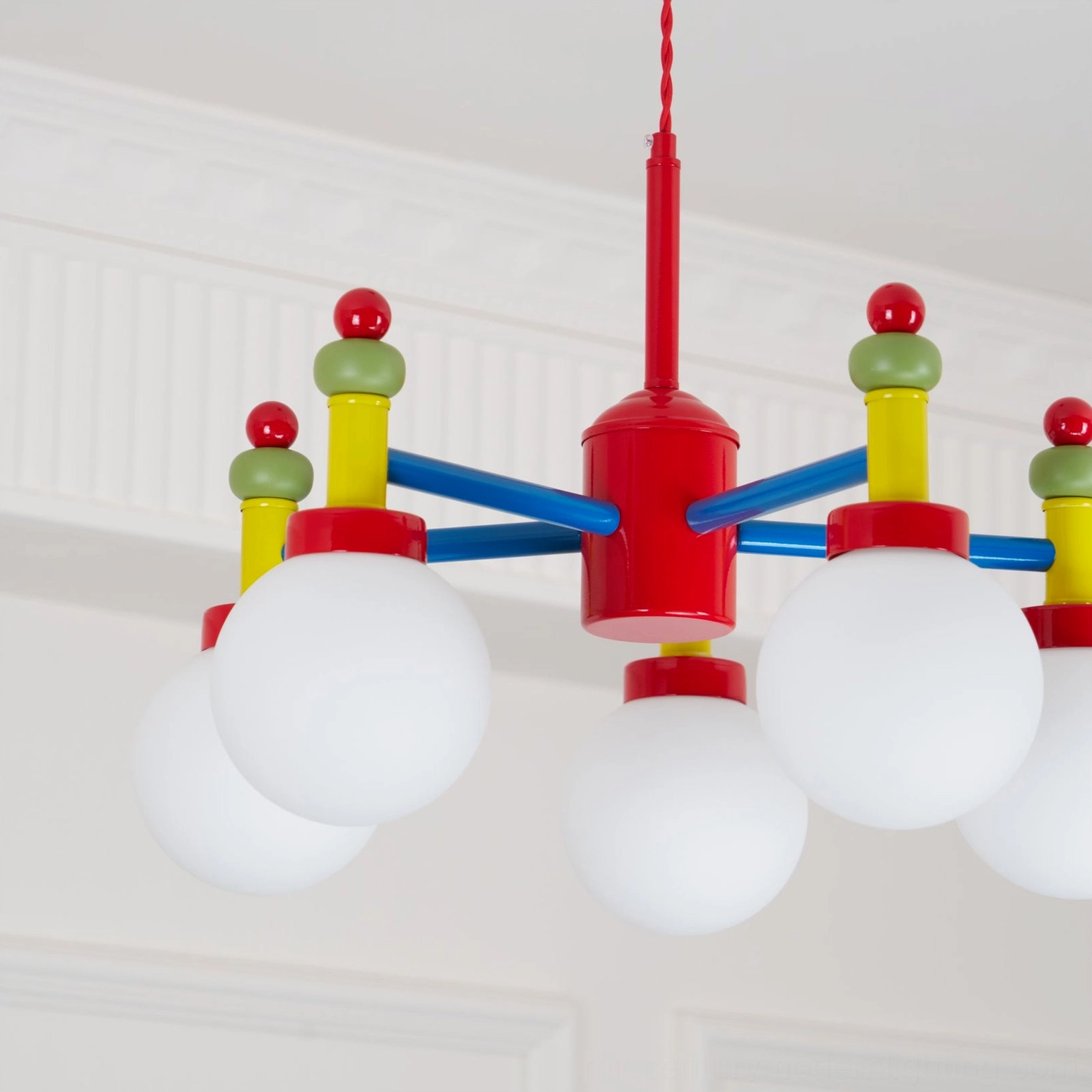 Pendant light with red green yellow blue color scheme and mid-century modern aesthetic