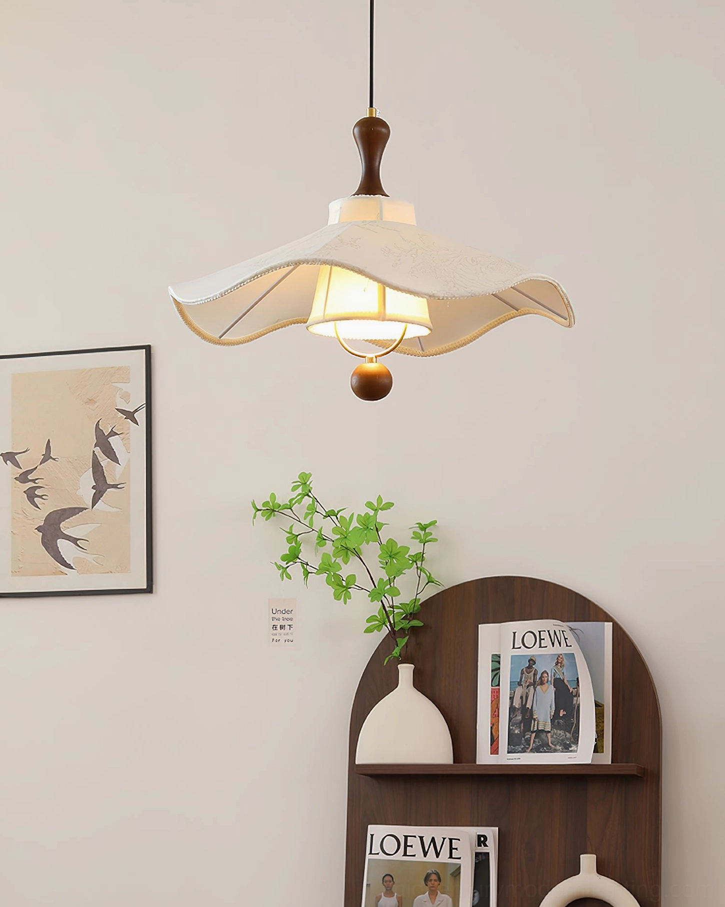 Illuminated Pendolo pendant lamp showing warm interior lighting and embroidered fabric detail