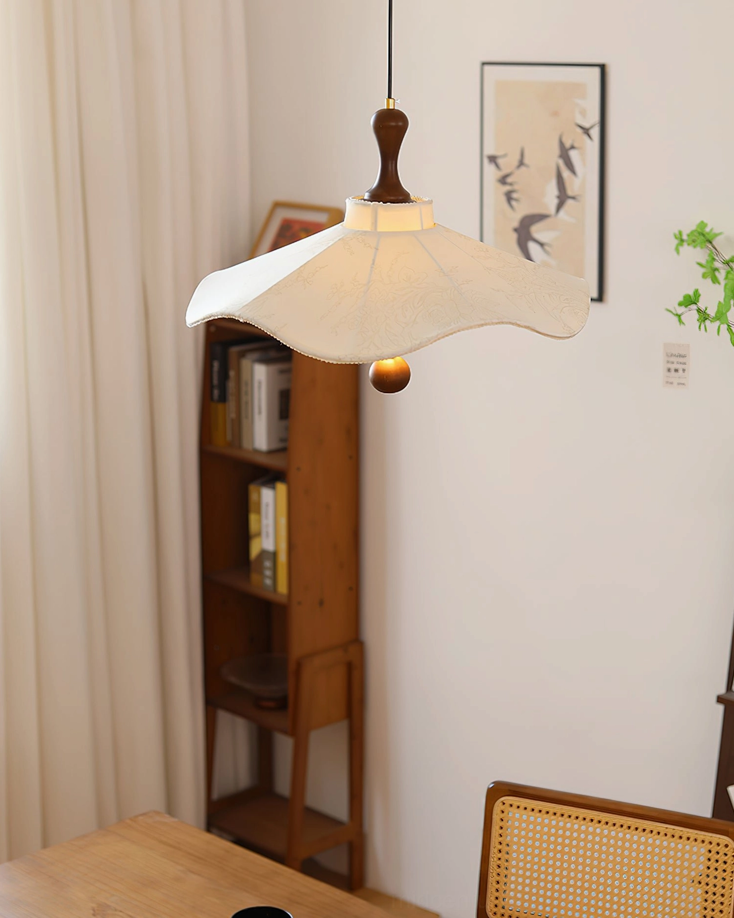 Pendolo ceiling pendant light in contemporary living room with natural light and bookshelf
