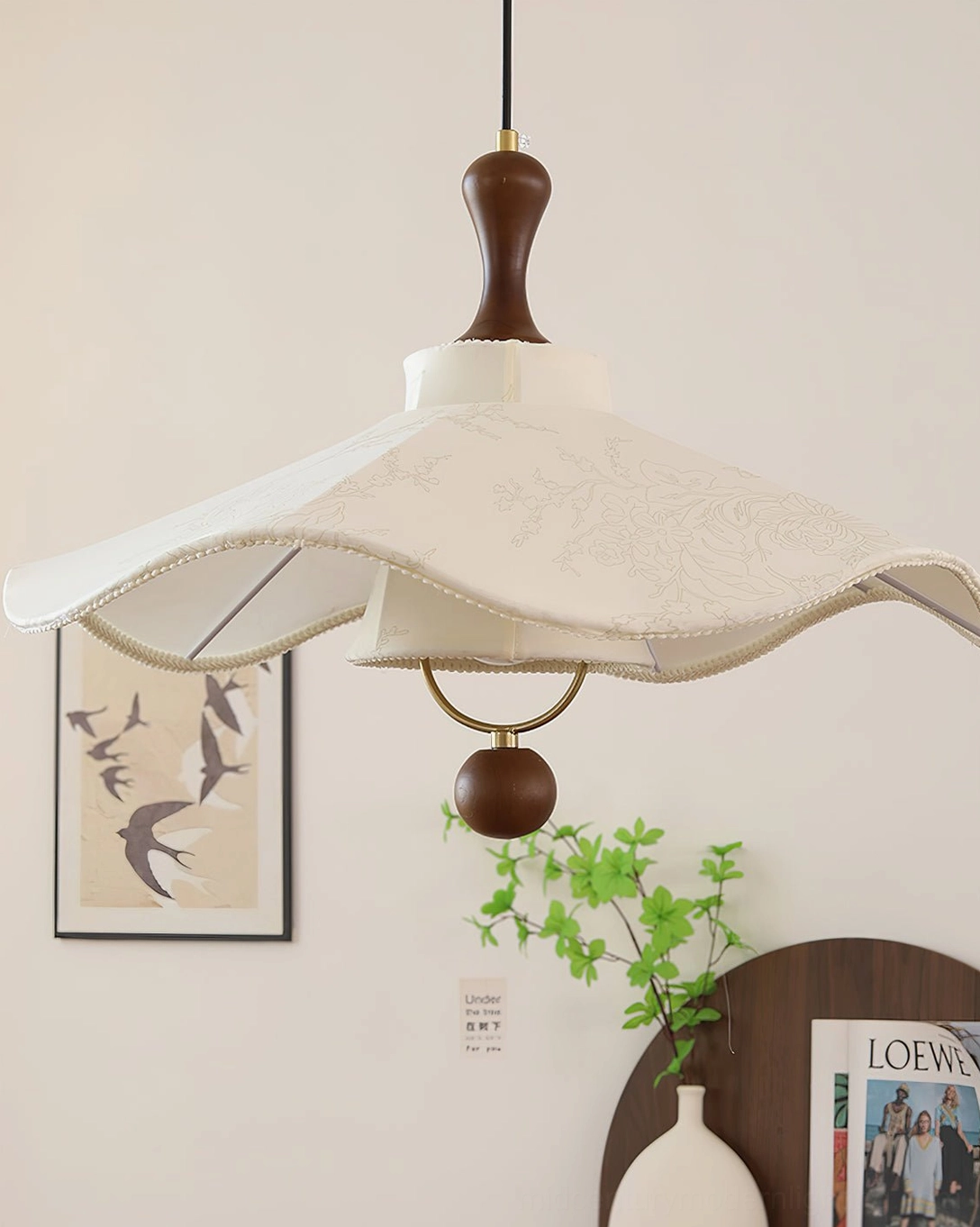 Pendolo off-white fabric pendant light hanging in home corner with green plants and decor