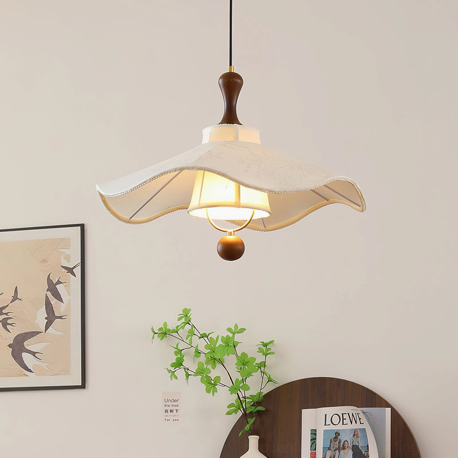 Pendolo fabric pendant light with stitched edge shade casting warm glow in home setting