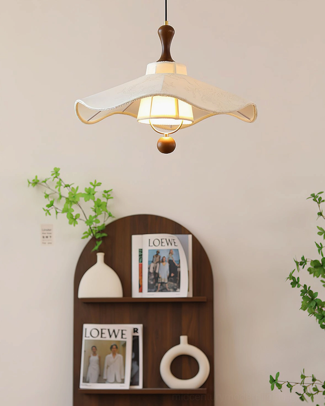 Pendolo pendant light with ruffled fabric shade over decorative shelf and natural plants
