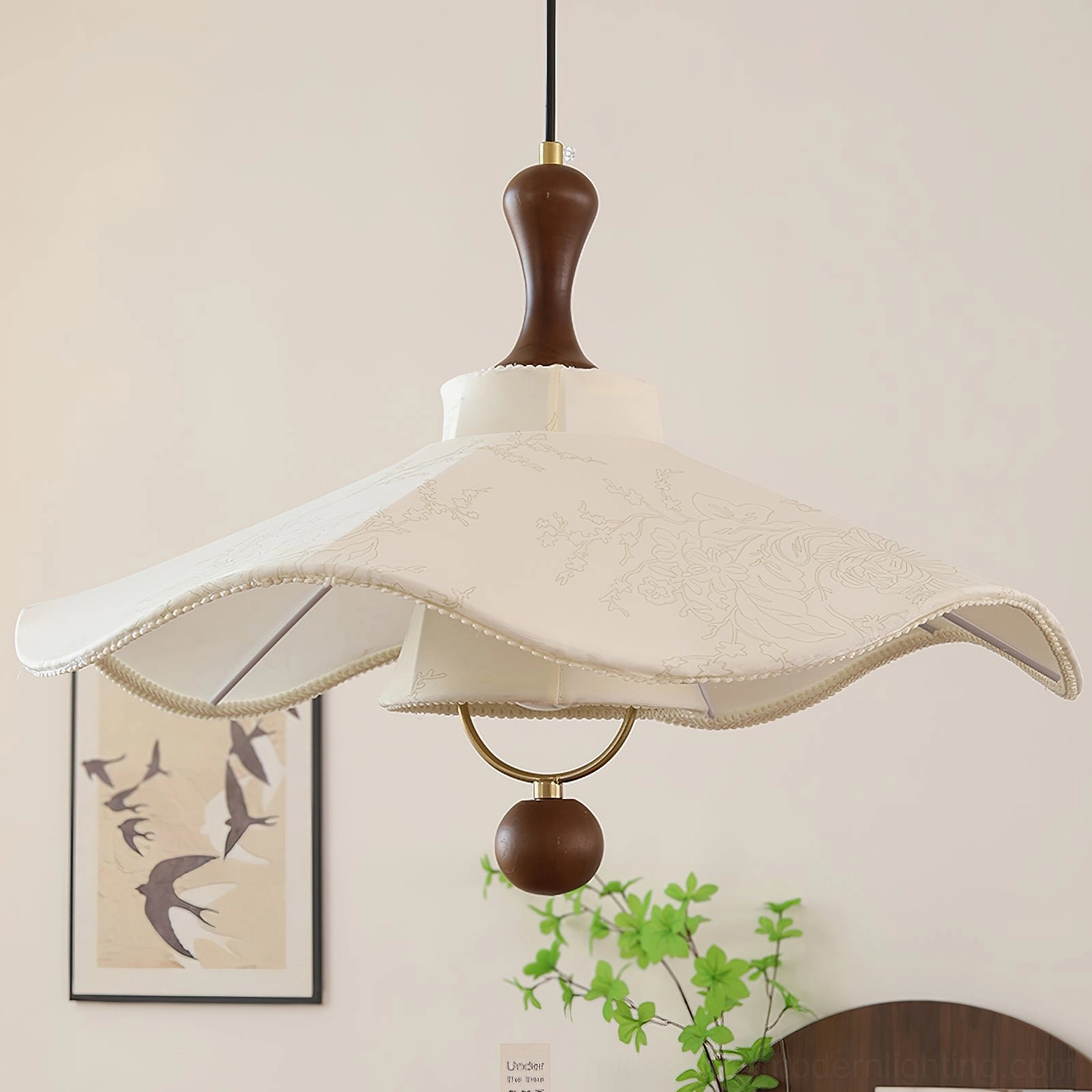 Pendolo pendant light with wooden hardware and embroidered fabric in minimalist home setting