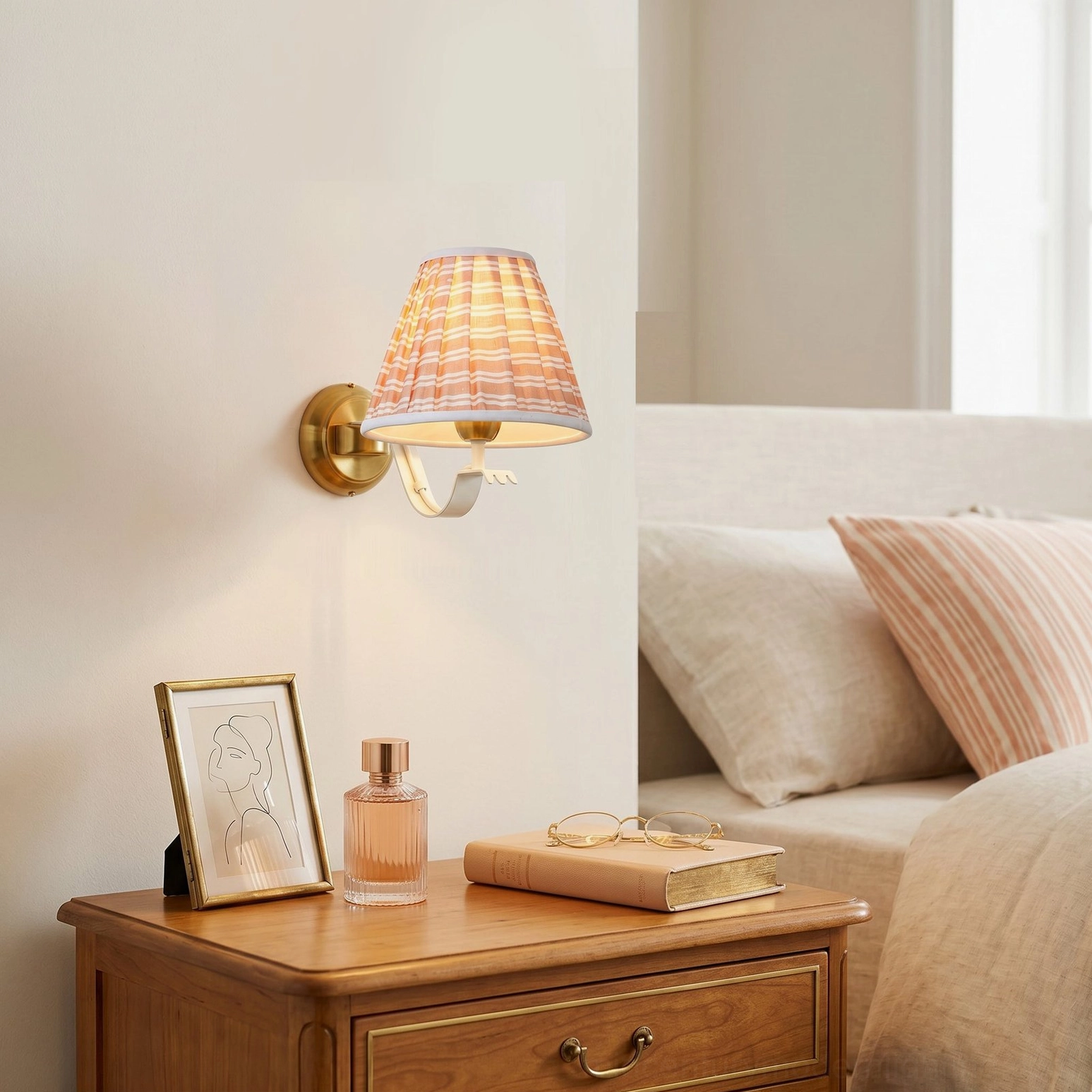 Penelope pleated wall sconce with brass curved arm in bedroom lounge side table corner accent lighting