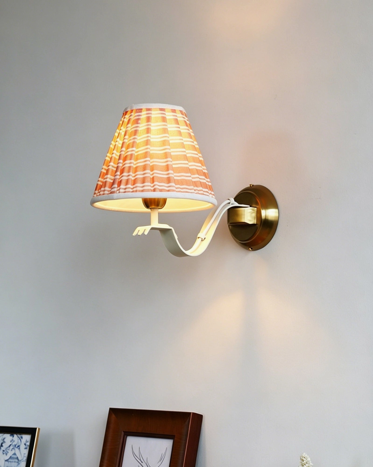 Penelope wall sconce installation in boho chic bedroom with vintage textiles and antique furnishings