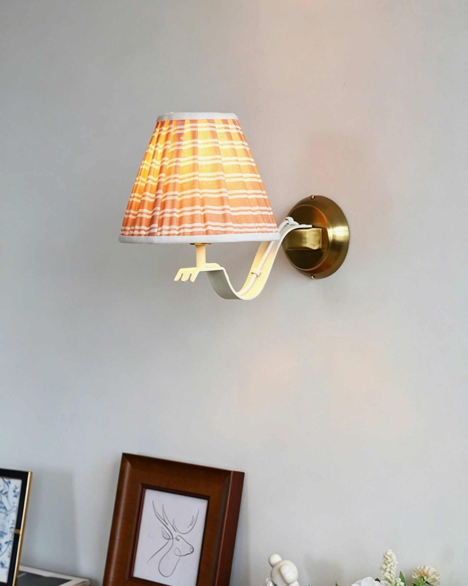 Penelope wall sconce providing task and ambient lighting for bedroom reading nook and nightstand area