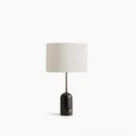 Penn marble table lamp with black marble base and white fabric shade, front view on white surface