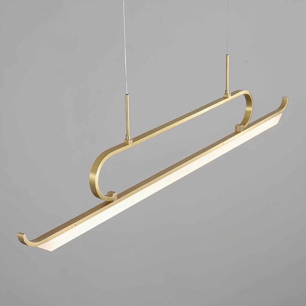 Penna linear chandelier close-up three-quarter view showing curved brass frame, LED panel, and sleek minimalist design details