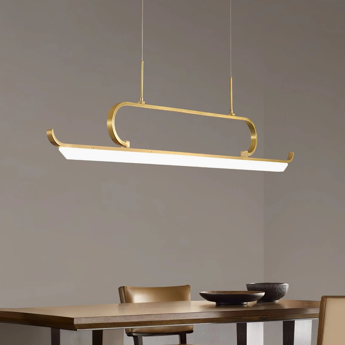 Penna linear chandelier three-quarter side view showing sleek matte brass frame and minimalist aesthetic