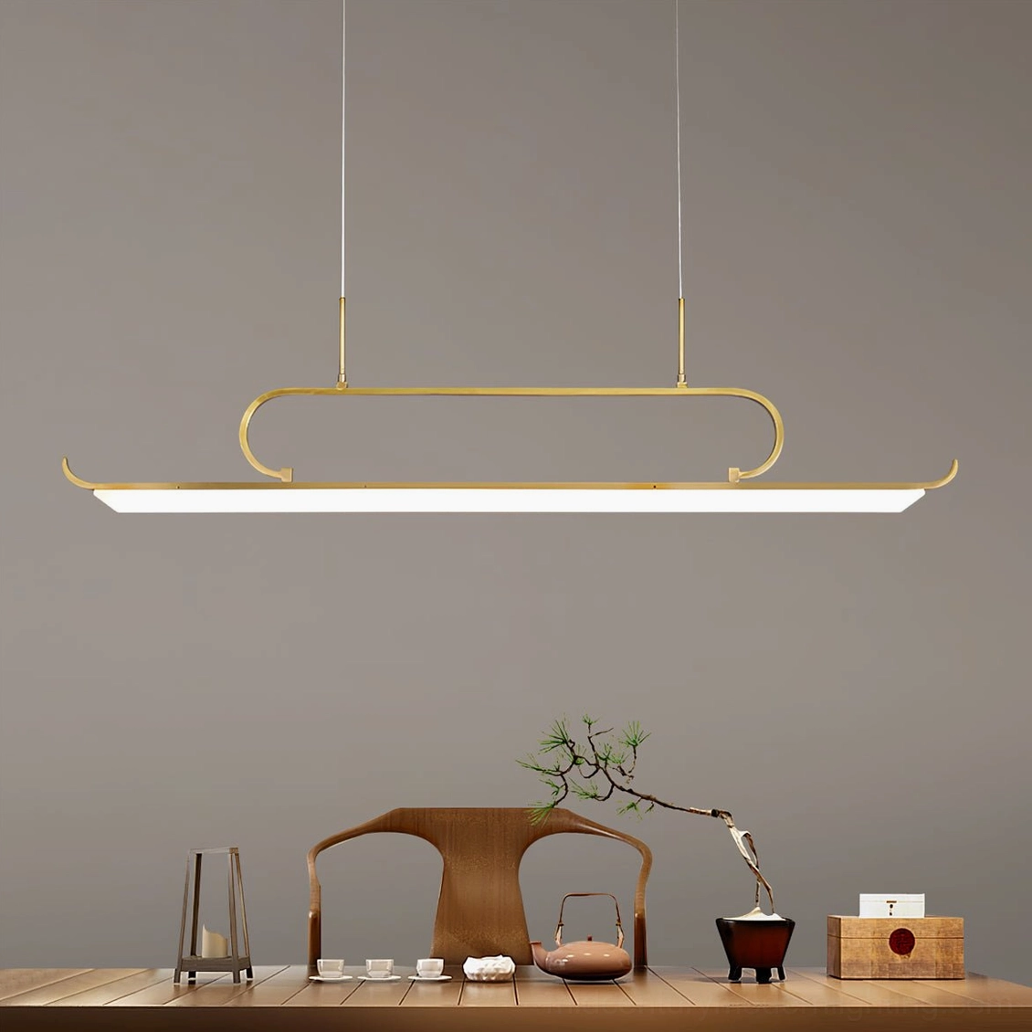 Penna pendant light installed above tea table in traditional room setting, demonstrating warm brass finish and ambient lighting