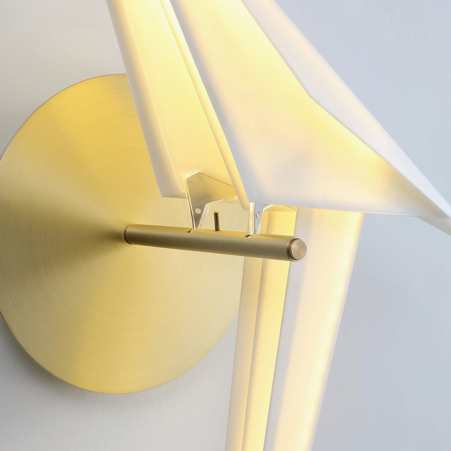 Perching bird wall lamp installed in contemporary interior space demonstrating warm ambient light quality and sculptural form