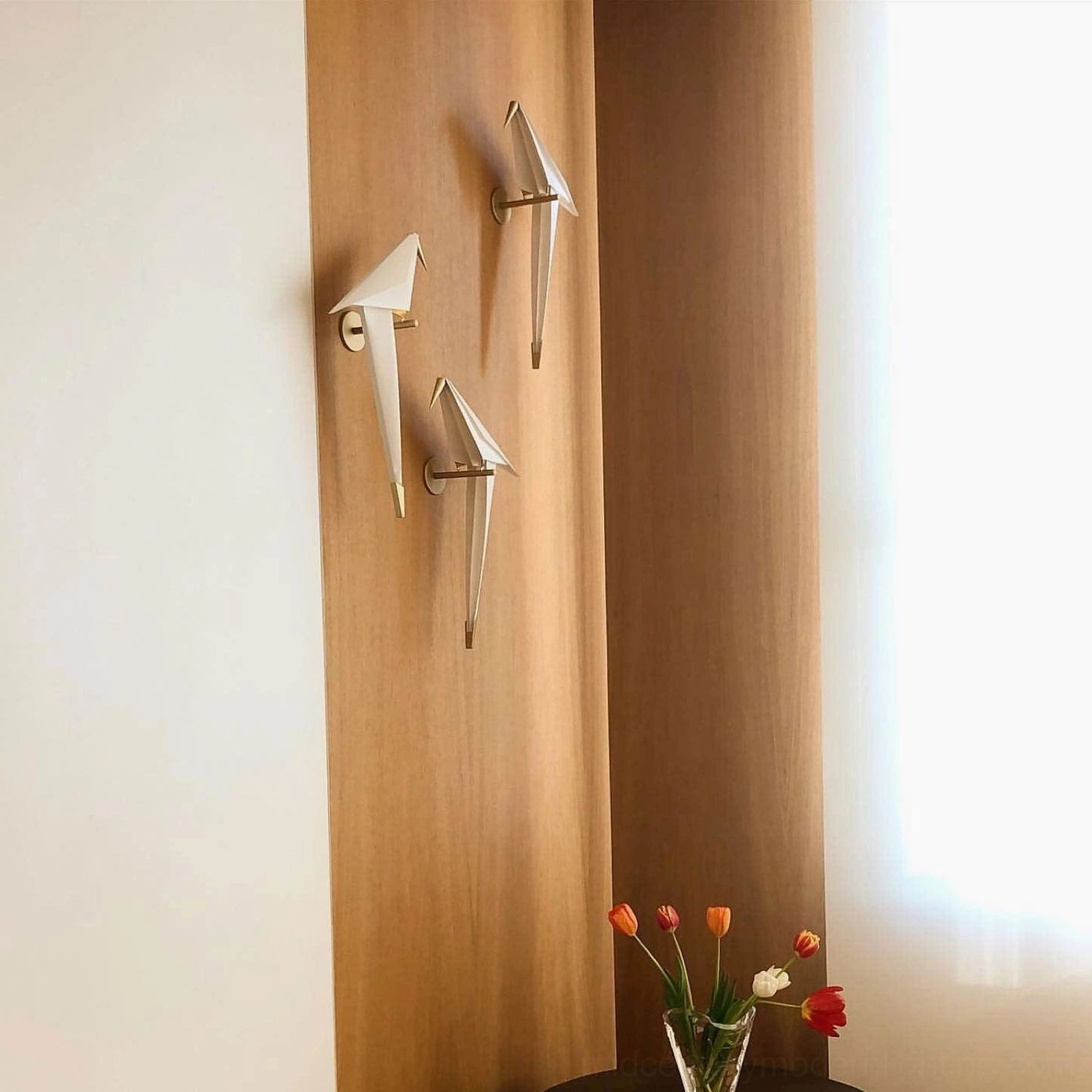 Three-pack perching bird wall lamps in mixed gold and white finishes displayed as minimalist design installation on corner wall