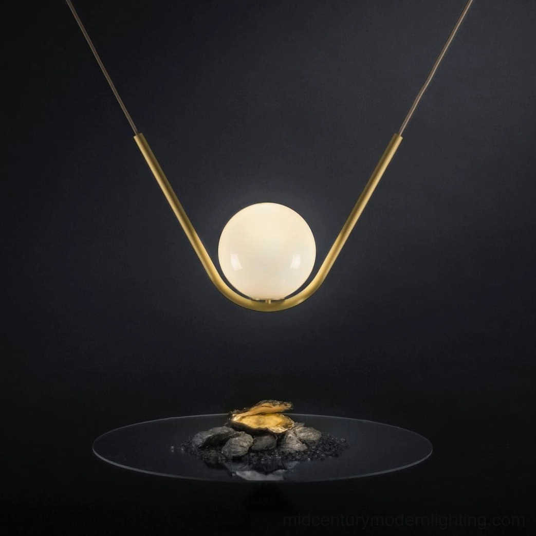 Perle pendant lamp sculptural quality showing brass frame and spherical handblown glass shade