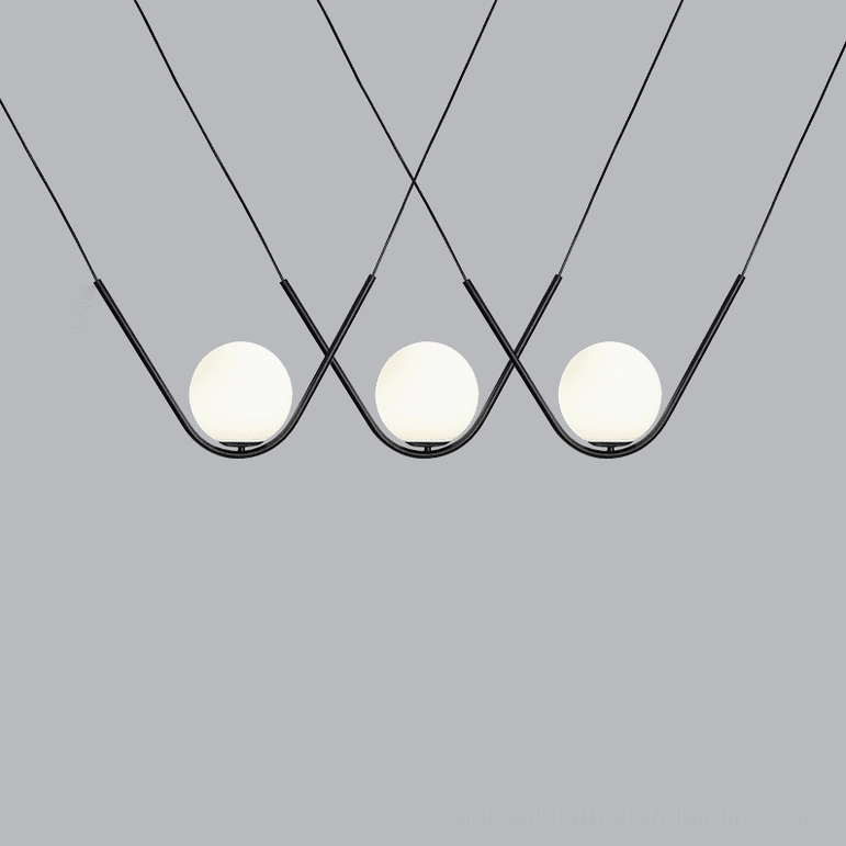 Perle pendant lamp side profile view showing elegant curved brass rod and glass globe proportions