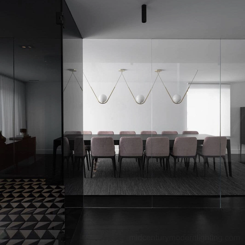 Perle three-head pendant light installation showing linear brass arrangement with multiple glass globes