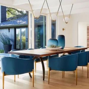 Three-head Perle pendant lights installed in modern luxury dining room with brass finish and white globe shades