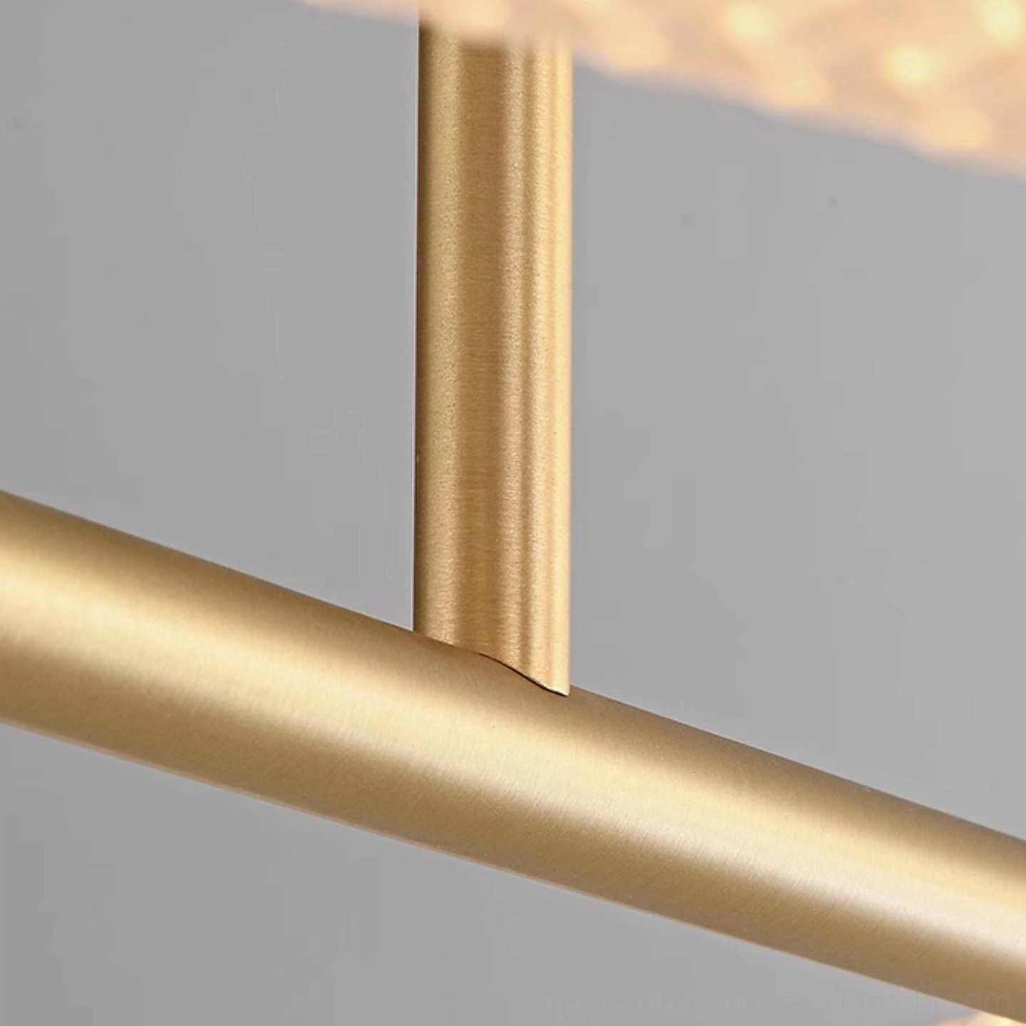 Close-up of Perpetual Infinity Pendant Lamp metal connection and mounting hardware in brushed brass finish