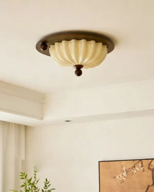 Perth mid-century modern ceiling light installed in minimalist bedroom with dark metal accents, low-angle view