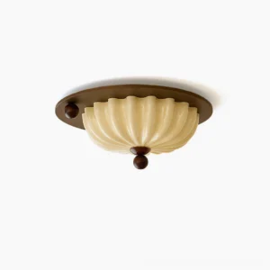 Perth pleated glass flush mount ceiling lamp, cream glass shade with walnut wood base, top-down studio close-up