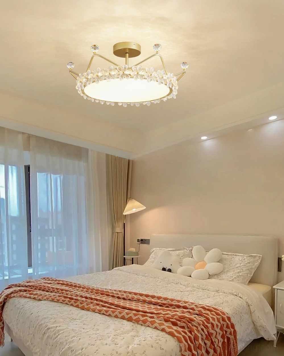 Gold petal crown ceiling fixture overhead view, master bedroom setting with classic warm lighting and elegant minimalist decor