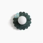 Petal marble wall sconce front view with deep green stone and frosted glass globe on white background