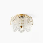 Petal Pearl ceiling light with sculptural glass petals and pearl detail, top-down view on white background