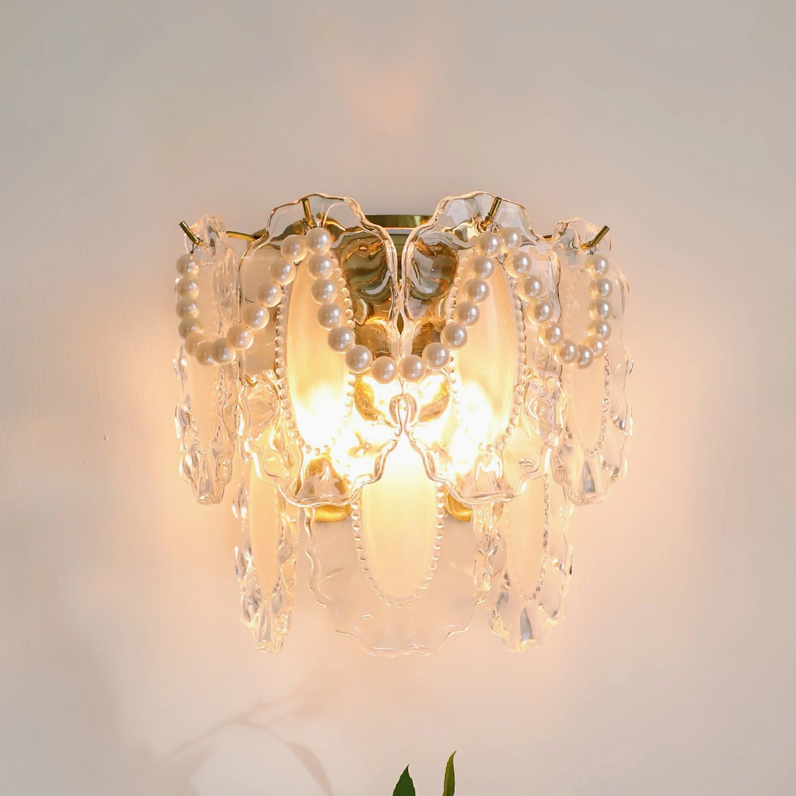 Petal Pearl Wall Light illuminated close-up showing warm glow through frosted glass and pearl details